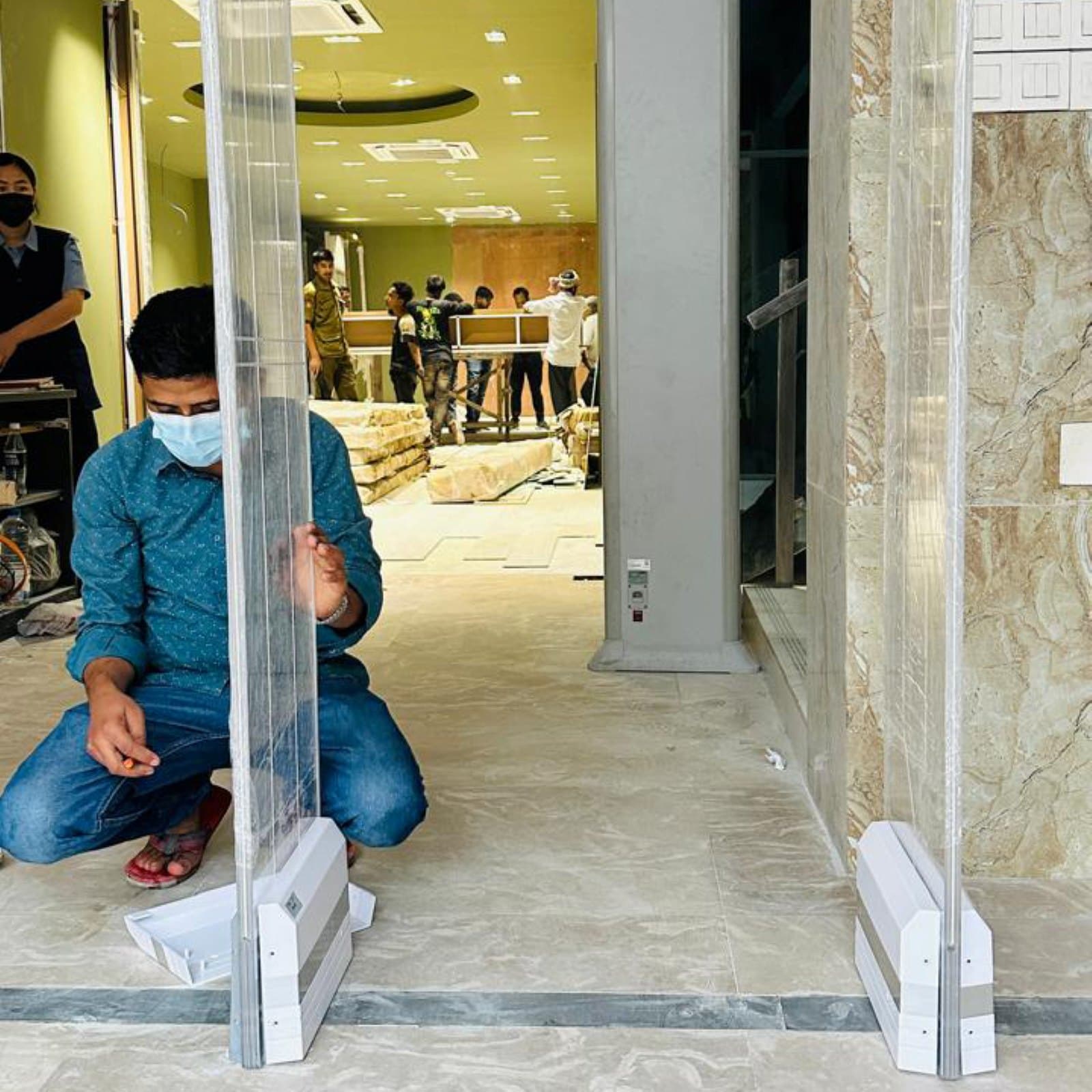 A RATS BD technician fitting an EAS pedestal at a high-value retail store in Banani, Dhaka