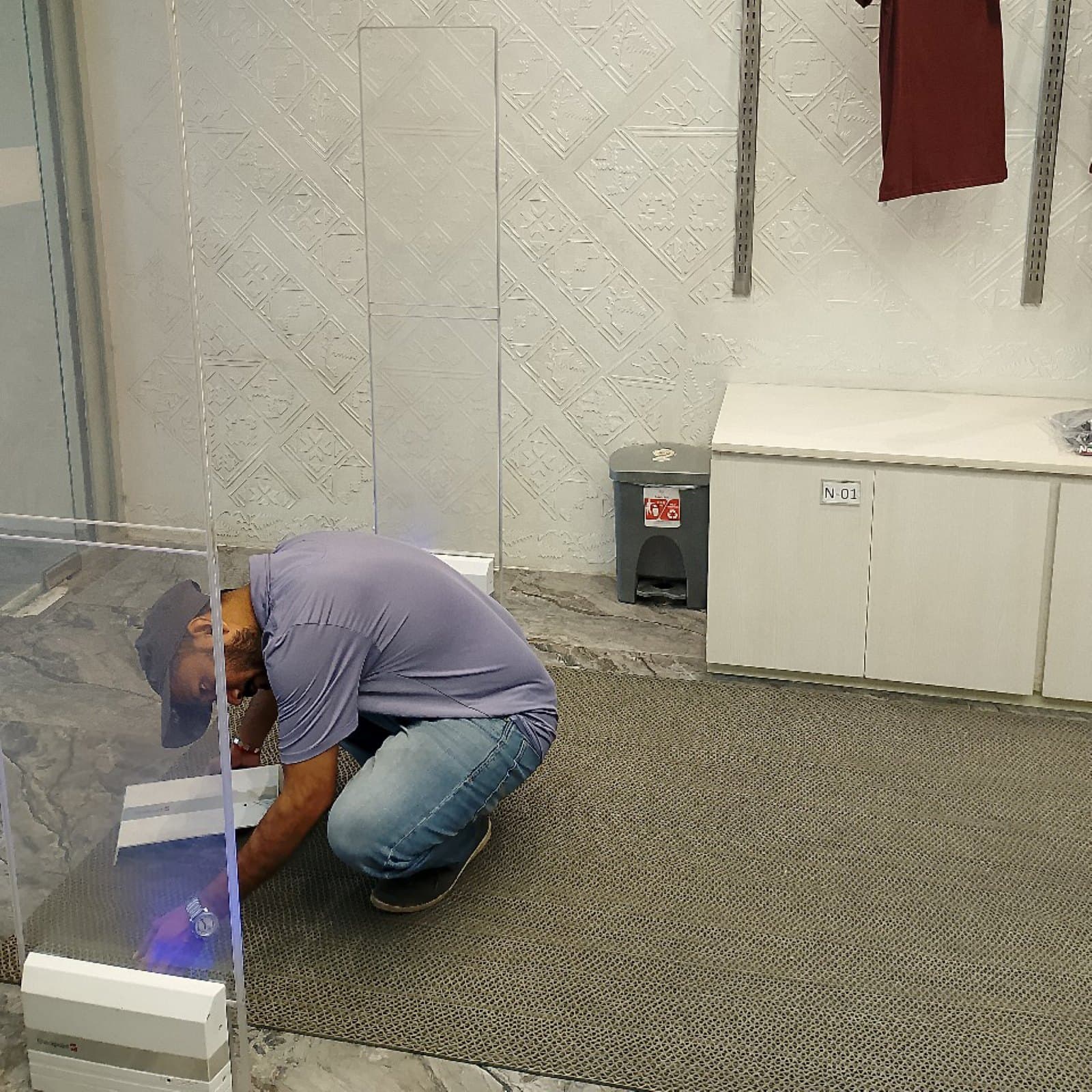 A RATS BD technician fitting an EAS pedestal at SaRa Lifestyle, Narayanganj